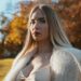 Portrait of elegant woman in fur coat in Munich park during fall. Beautiful autumn colors.